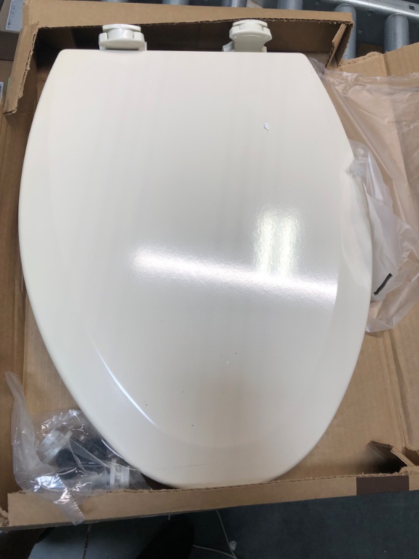 Photo 3 of Bemis 1500EC 146 Molded Wood Elongated Toilet Seat With Easy Clean & Change Hinge, Almond Almond 1 Pack Elongated Toilet Seat SCRATCH ON SIDE OF TOILET SEAT 