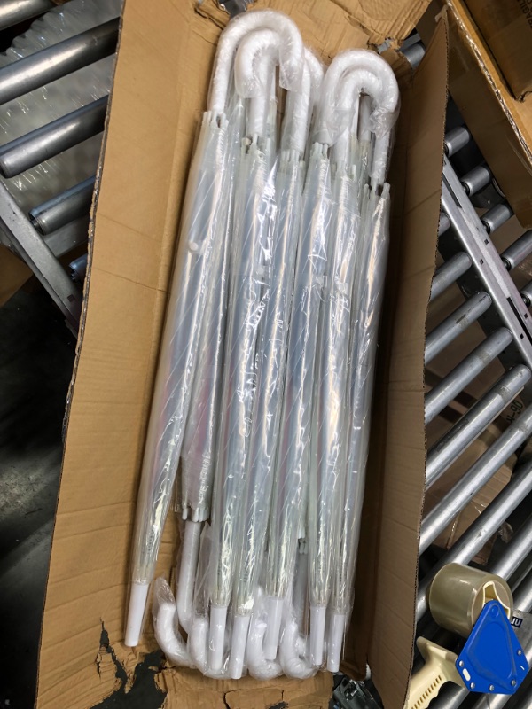 Photo 1 of 12 Pack of Clear Umbrellas with white handles.