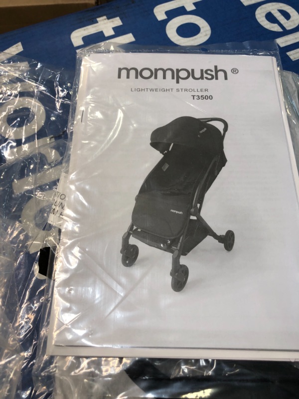 Photo 4 of Mompush Lithe, Lightweight Stroller, Compact One-Hand Fold Luggage-Style Travel Stroller for Airplane Friendly, Reclining Seat and XL Canopy, with Rain Cover & Travel Carry Bag & Cup Holder Black