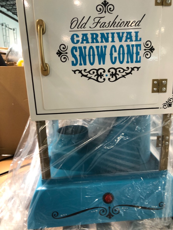 Photo 9 of Nostalgia Snow Cone Cart, 48-Inch, Makes 48 ICY Treats, Vintage Snow Machine Includes Metal Scoop, Storage Compartment, Wheels for Easy Mobility, White/Blue