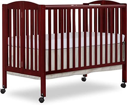 Photo 1 of Dream On Me Full Size 2-in-1 Folding Stationary Side Crib in Cherry, Locking Wheels, Folds Flat for Storage, Comes with Teething Guard, Non-Toxic Finish