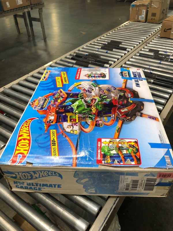 Photo 1 of Hot Wheels Track Set, Ultimate Garage Toy Vehicle Playset With Moving T-Rex Dinosaur, Storage For 100+ Vehicles, 3ft+ Tall
