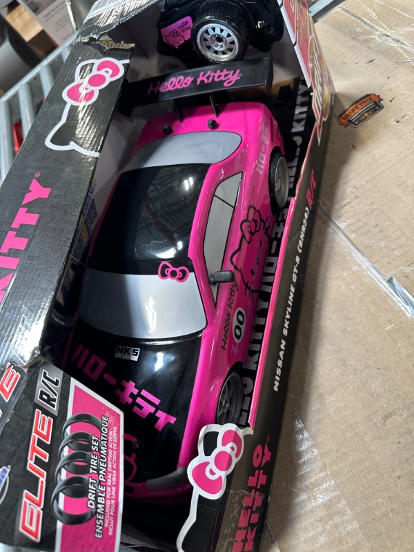 Photo 2 of Jada Toys Hello Kitty Nissan Skyline GT-R (Bnr34) Drift Power Slide Elite R/C, USB Charging, with 4 Extra Tires, Pink