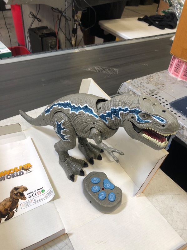 Photo 1 of FANURY Remote Control Dinosaur Toys for 3-12 Year Old Boys Girls, LED Light Up Walking and Roaring Realistic T-Rex Dinosaur Toy with Glowing Eyes Projection Spray Function for Kids Gifts Age 3+ 2.4G Gray T-Rex  (NEEDS BATTERIES)