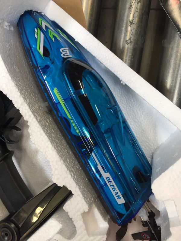 Photo 3 of BEZGAR TX121 RC Boat, Remote Control Boat for Pools and Lakes, 2.4GHz Racing RC Boats for Adults and Kids, Top Speed 20+MPH, Features with Transparent Cover and LED Effect, with Rechargeable Battery Blue-yellow