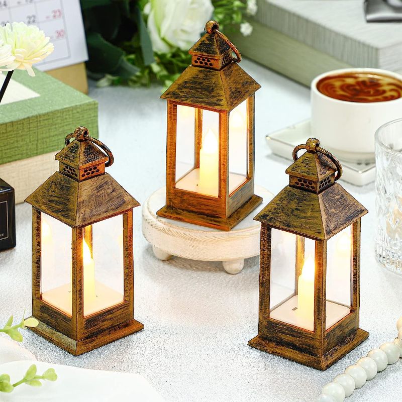 Photo 1 of 12 Set Candle Lantern Mini Lanterns with Flickering LED Candle Vintage Lantern 5.5'' Decorative Hanging Candle Lantern Battery Powered Decorative Lantern for Halloween Table Wedding Decor (Bronze)