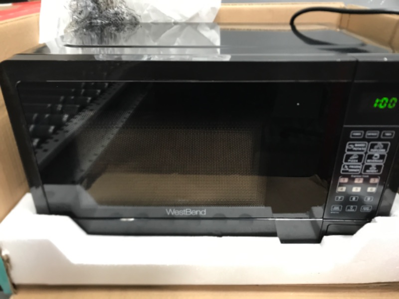 Photo 1 of ***TESTED/ POWERS ON***West Bend WBMW71B Microwave Oven 700-Watts Compact with 6 Pre Cooking Settings, Speed Defrost, Electronic Control Panel and Glass Turntable, Black