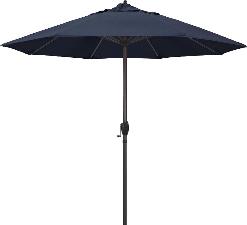 Photo 1 of California Umbrella 9' Rd Sunbrella Aluminum Patio Umbrella, Crank Lift, Auto Tilt, Bronze Pole, Spectrum Indigo Fabric
