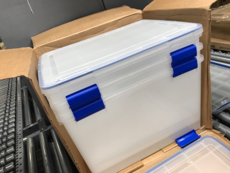 Photo 2 of **DAMAGED**
IRIS USA 70 Quart WEATHERPRO Plastic Storage Box with Durable Lid and Seal and Secure Latching Buckles, Clear With Blue Buckles, Weathertight, 3 Pack 70 Quart - 3 Pack
**MISSING LID**