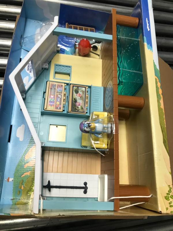 Photo 2 of Bluey Beach Cabin Playset, with Exclusive Figure with Goggles. Includes 10 Play Pieces and Sticker Sheet