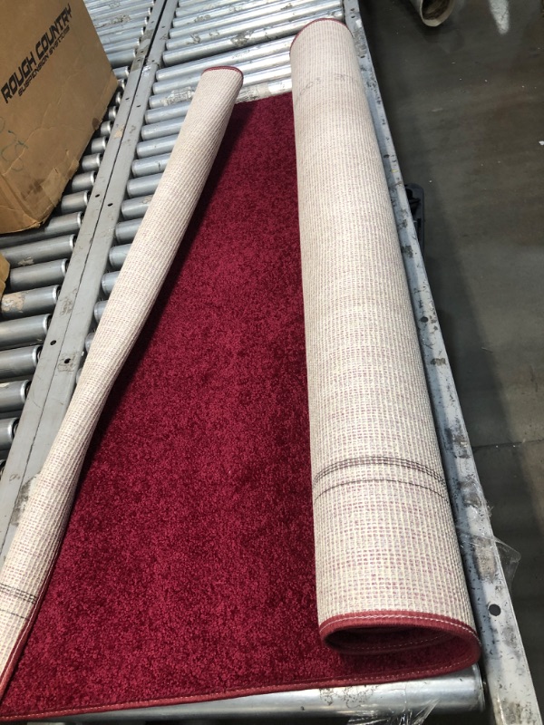 Photo 1 of 4' x 6' red rug.