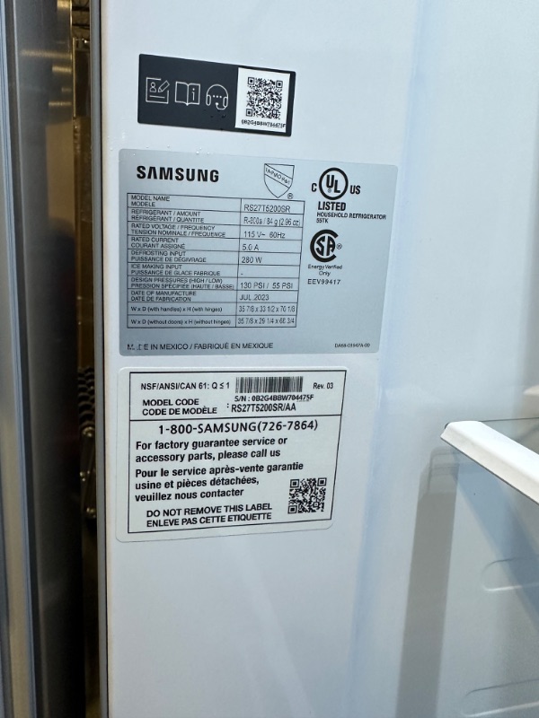 Photo 3 of Samsung 27.4-cu ft Side-by-Side Refrigerator with Ice Maker (Fingerprint Resistant Stainless Steel)
*small stain by ice box* - small dent onside of fridge