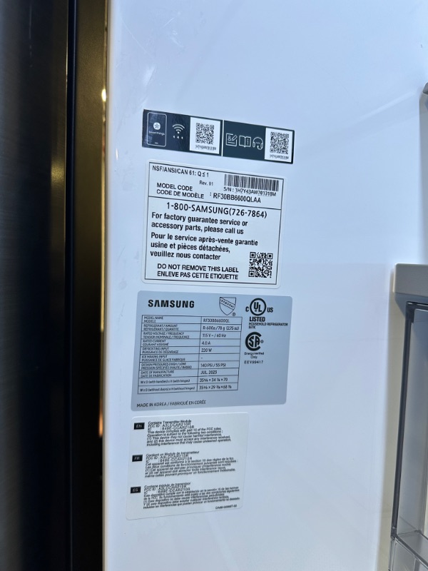 Photo 3 of Samsung 30.1-cu ft Smart French Door Refrigerator with Dual Ice Maker and Door within Door (Stainless Steel- All Panels) ENERGY STAR
*product has residue left inside* *small dent in front*