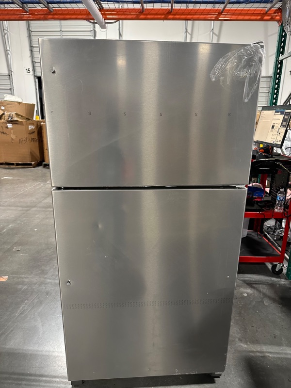 Photo 2 of Whirlpool 20.5-cu ft Top-Freezer Refrigerator (Fingerprint Resistant Stainless Steel)
*fridge handles are located inside for installation* *product is factory sealed* *small dent behind product*

*product plug is bent- view picture*
