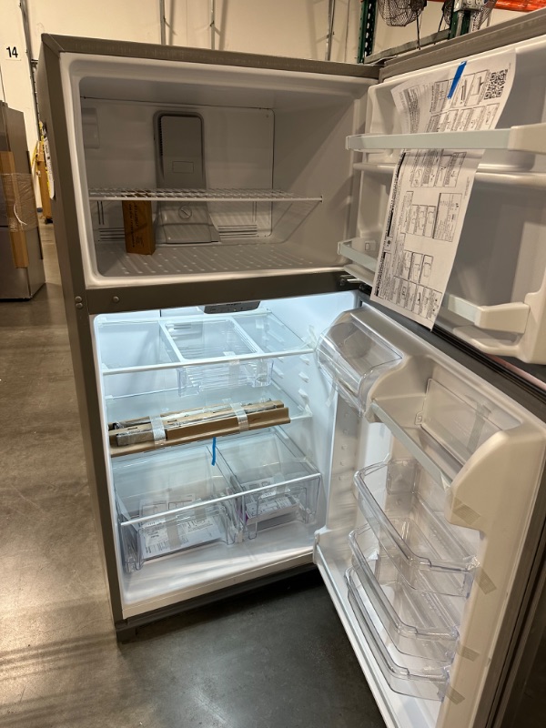 Photo 6 of Whirlpool 20.5-cu ft Top-Freezer Refrigerator (Fingerprint Resistant Stainless Steel)
*fridge handles are located inside for installation* *product is factory sealed* *small dent behind product*

*product plug is bent- view picture*
