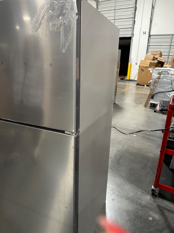 Photo 9 of Whirlpool 20.5-cu ft Top-Freezer Refrigerator (Fingerprint Resistant Stainless Steel)
*fridge handles are located inside for installation* *product is factory sealed* *small dent behind product*

*product plug is bent- view picture*
