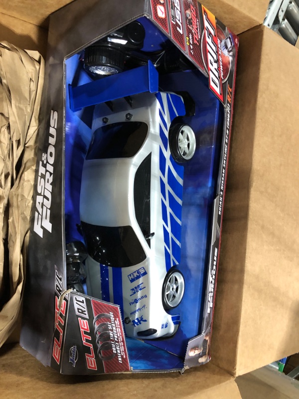 Photo 1 of Jada Toys Fast & Furious Brian's Nissan Skyline GT-R (BN34) Drift Power Slide RC Radio Remote Control Toy Race Car with Extra Tires, 1:10 Scale, Silver/Blue (99701)