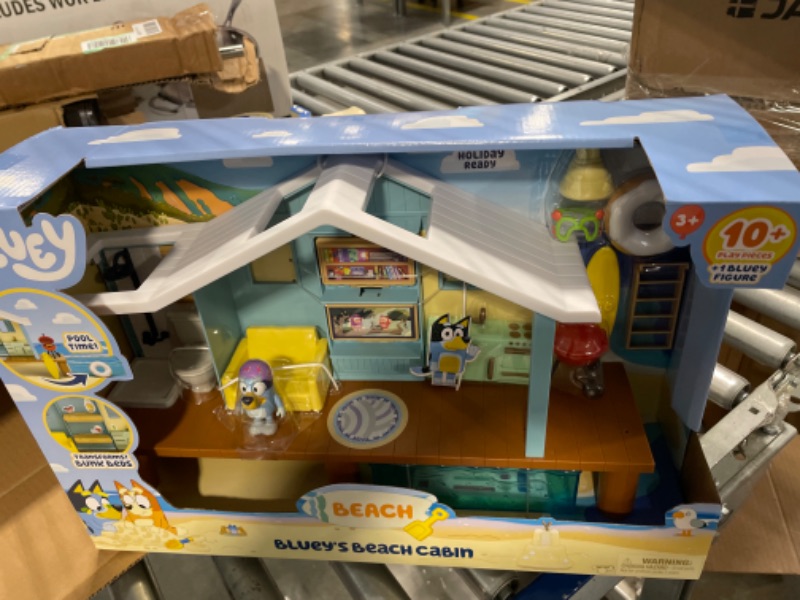 Photo 2 of Bluey Beach Cabin Playset, with Exclusive Figure with Goggles. Includes 10 Play Pieces and Sticker Sheet