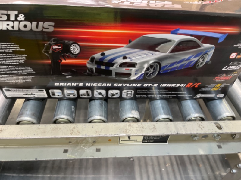 Photo 3 of Jada Toys Fast & Furious Brian's Nissan Skyline GT-R (BN34) Drift Power Slide RC Radio Remote Control Toy Race Car with Extra Tires, 1:10 Scale, Silver/Blue (99701)