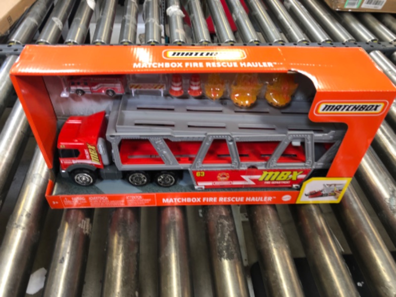 Photo 2 of ?Matchbox Fire Rescue Hauler Playset Themed Hauler with 1 Fire-Themed Vehicle, Holds 16 Cars, Easy-Release Ramp, 8 Accessories & Storage, for 3 & Up [Amazon Exclusive]
