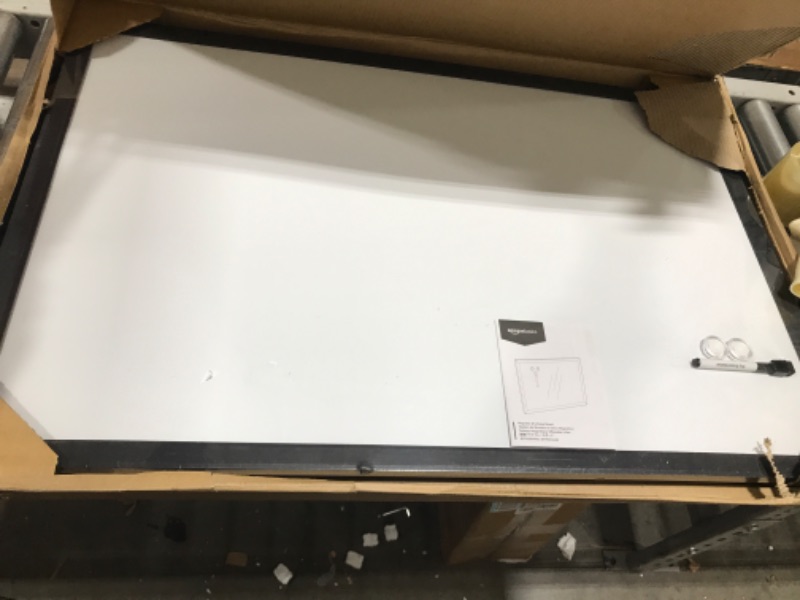 Photo 1 of Amazon Basics Magnetic Dry Erase White Board, 35 x 23-Inch Whiteboard - Black Wooden Frame 23"x35" Magnetic, Wood Frame