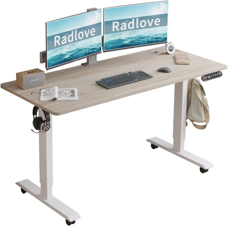 Photo 1 of Radlove Electric Standing Desk, 55 x 24 Height Adjustable Computer Desk Sit Stand Desk Home Office Desks with Splice Board and A Under Desk Cable Management Tray (White Frame + Oak Top)
