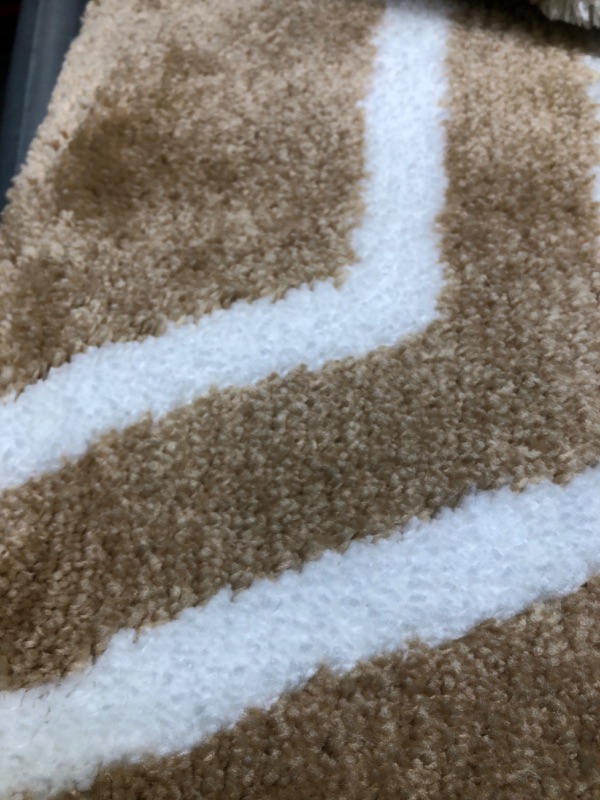Photo 2 of 2 brown and white rugs