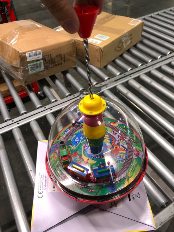 Photo 1 of Lena 52120 tin Toys Panorama Ø19 cm, Plastic Humming, Classical Pump Mechanism, Musical Locomotive, Stand, Spinning top for Children from 18 Months, Colorful --- Couldn't test needs batteries ----
