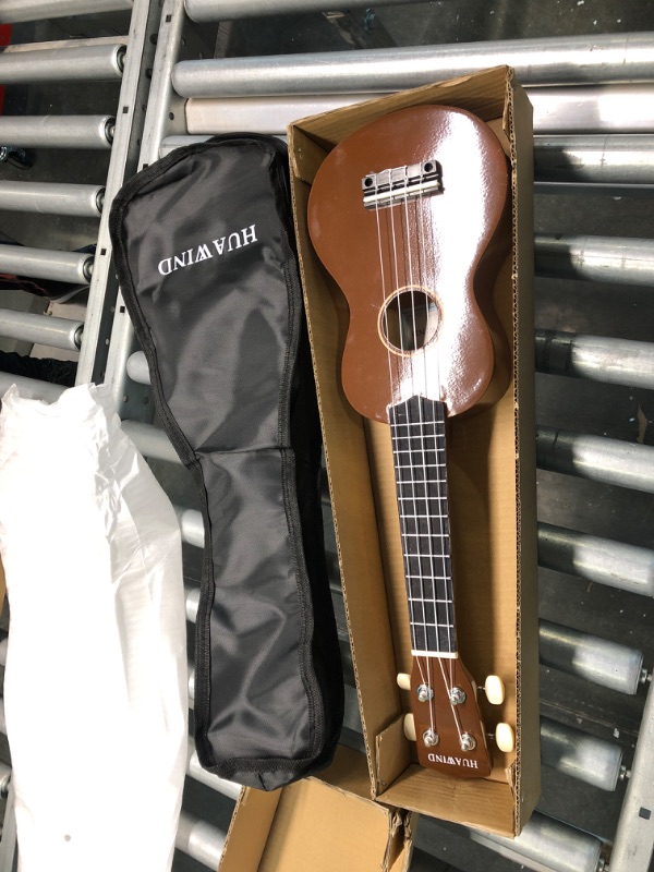 Photo 2 of HUAWIND 21 Inch Soprano Ukulele for Beginners, Kid Guitar Four String Wood Children Ukulele with Gig Bag (Brown) Brown Ukulele