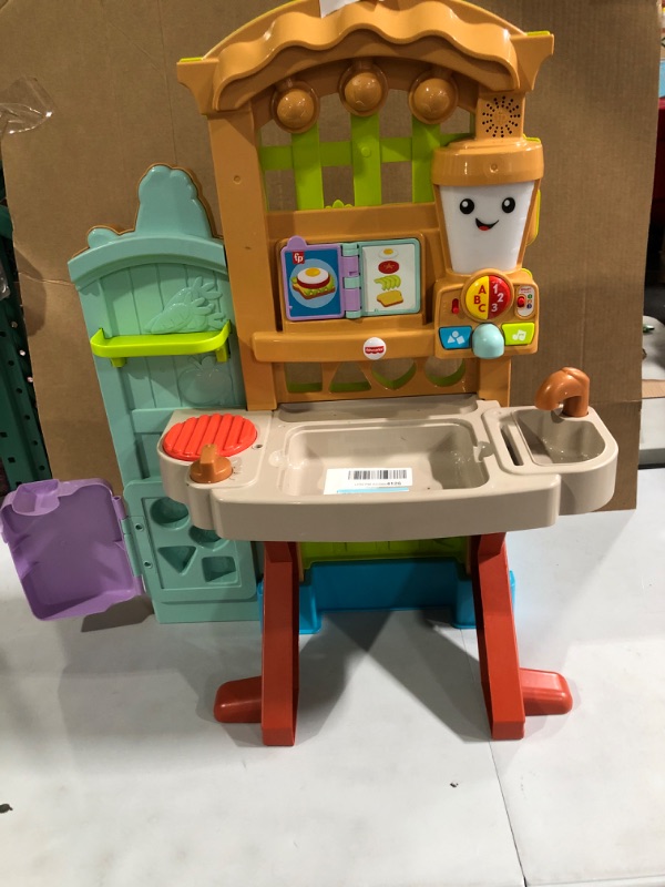 Photo 2 of Fisher-Price Laugh & Learn Grow-the-Fun Garden to Kitchen.