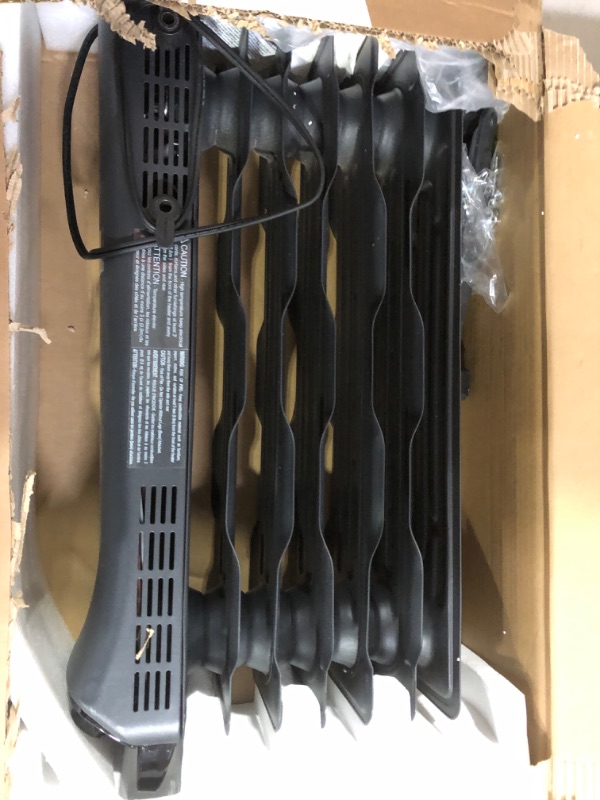 Photo 2 of Amazon Basics Portable Radiator Heater with 7 Wavy Fins, Manual Control, Black, 1500W