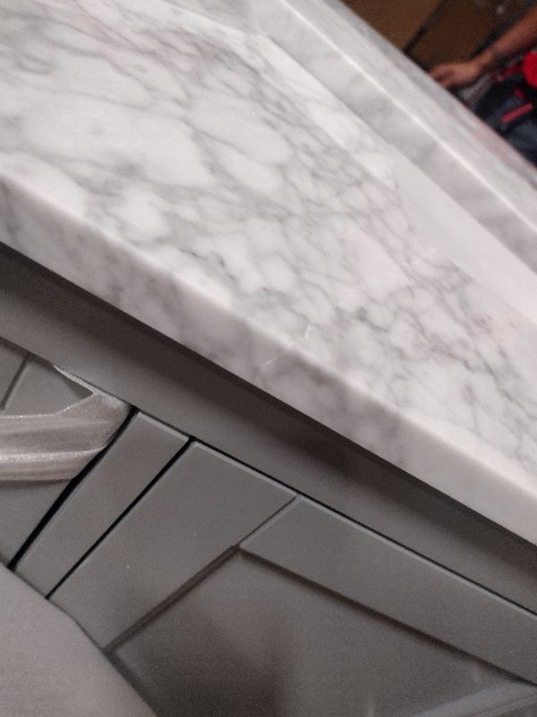 Photo 12 of **CORNER DAMAGE**
Stockham 49 in. W x 22 in. D Bath Vanity in Chilled Gray with Marble Vanity Top in Carrara White with White Basin
