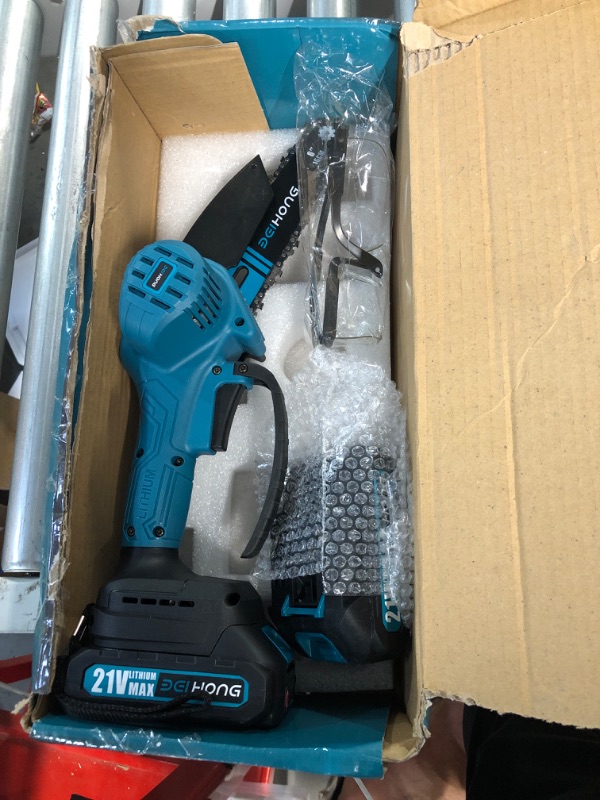 Photo 2 of **JUST THE CHAINSAW AND 2 BATTERIES**
Mini Chainsaw 6-Inch with Battery, Cordless, Handheld Blue