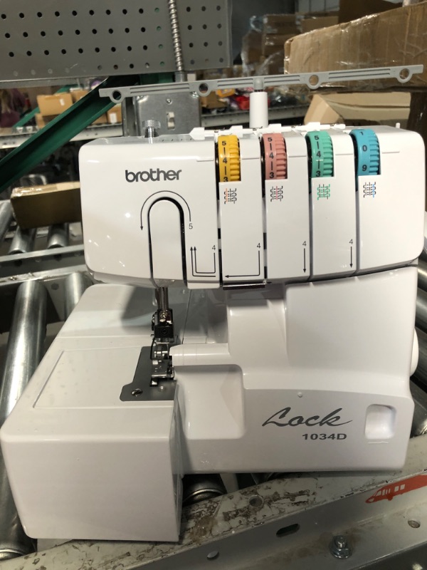 Photo 8 of (System timing is off. Jams every cycle) *USED* Brother Serger, 1034D, Heavy-Duty Metal Frame Overlock Machine, 1,300 Stitches Per Minute, Removeable Trim Trap, 3 Included Accessory Feet,White