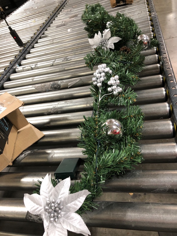 Photo 2 of Adeeing Christmas Garland with Lights, 6 ft Pre-lit Silver White Christmas Garland with Pinecones Berries Poinsettia Battery Operated Lights for Indoor Outdoor Fireplace Staircase Decoration
