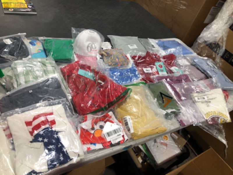 Photo 1 of Box lot of clothing. Assortment of sizes and styles for men and women and kids. Box lot is sold as is.