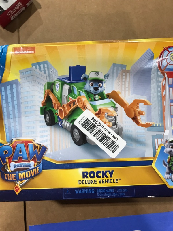 Photo 2 of Paw Patrol, Rocky’s Deluxe Movie Transforming Toy Car with Collectible Action Figure, Kids Toys for Ages 3 and up Deluxe Transforming Car