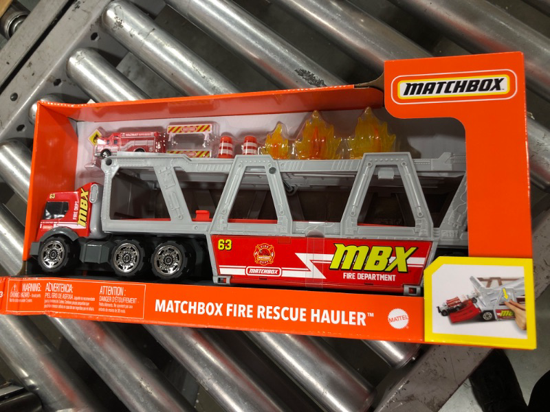 Photo 1 of ?Matchbox Fire Rescue Hauler Playset Themed Hauler with 1 Fire-Themed Vehicle, Holds 16 Cars, Easy-Release Ramp, 8 Accessories & Storage, for 3 & Up [Amazon Exclusive]