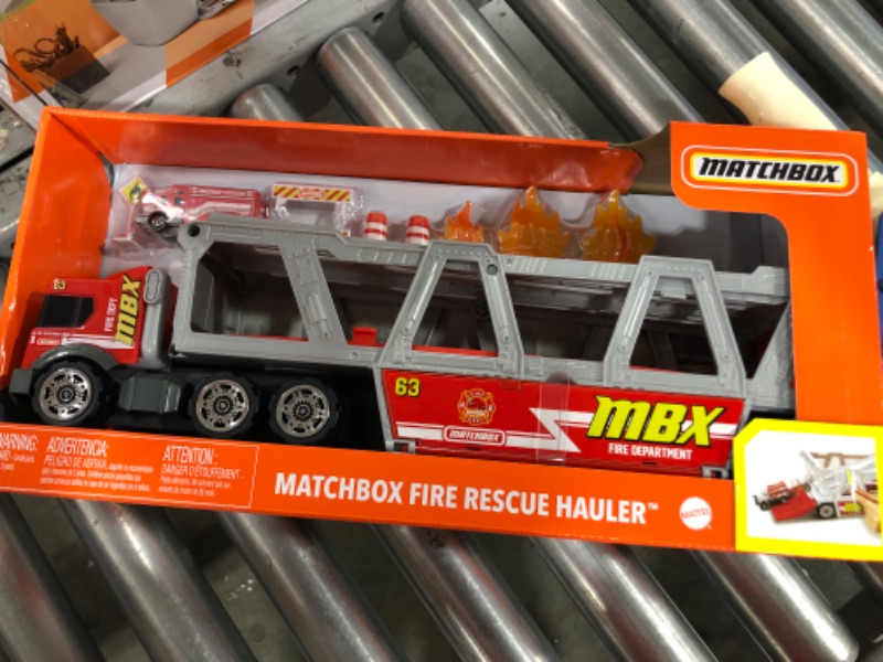 Photo 2 of ?Matchbox Fire Rescue Hauler Playset Themed Hauler with 1 Fire-Themed Vehicle, Holds 16 Cars, Easy-Release Ramp, 8 Accessories & Storage, for 3 & Up [Amazon Exclusive]