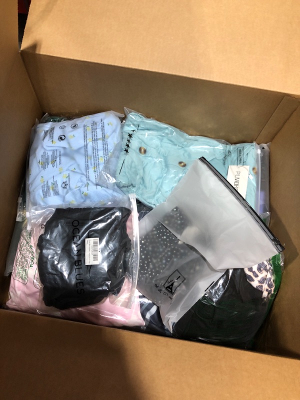 Photo 1 of Clothing box lot. Over 20 pieces of brand new clothing items for men, women, and kids. Sold as is.