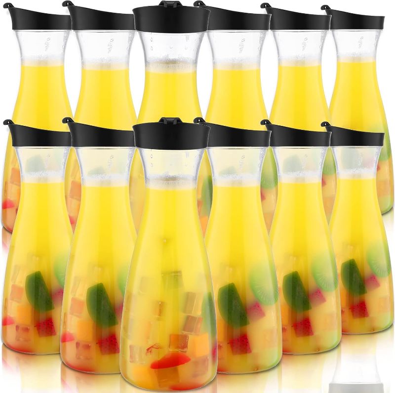 Photo 1 of 12 Pcs Water Carafe with Flip Top Lid 34 oz Plastic Carafe with Black Lid Clear Plastic Water or Juice Beverage Pitcher Beverage Pitcher Jug for Restaurant Party School Bar Juice Milk Coffee
