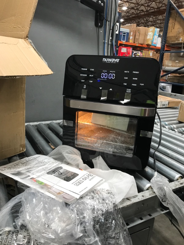 Photo 2 of **SIDE OF OVEN IS FRACTURED BUT FUNCTIONAL**
NUWAVE Brio Air Fryer Smart Oven, 15.5-Qt X-Large Family Size, Countertop Convection Rotisserie Grill Combo, Non-Stick Drip Tray, Stainless Steel Rotisserie Basket. 15.5QT Brio