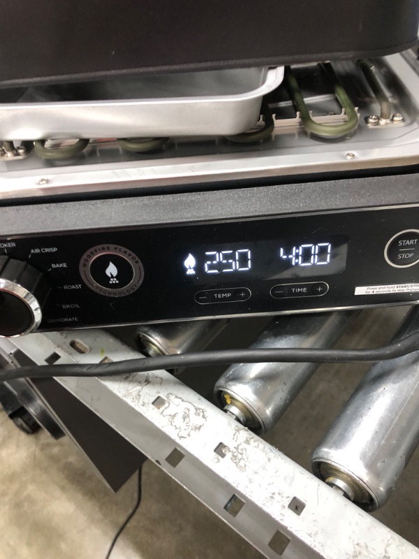 Photo 1 of Ninja OG701 Woodfire Outdoor Grill & Smoker, 7-in-1 Master Grill, BBQ Smoker, & Air Fryer plus Bake, Roast, Dehydrate, & Broil, uses Ninja Woodfire Pellets, Weather-Resistant, Portable, Electric, Grey