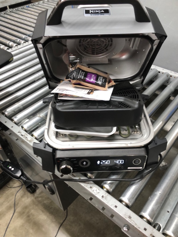 Photo 1 of Ninja OG701 Woodfire Outdoor Grill & Smoker, 7-in-1 Master Grill, BBQ Smoker, & Air Fryer plus Bake, Roast, Dehydrate, & Broil, uses Ninja Woodfire Pellets, Weather-Resistant, Portable, Electric, Grey