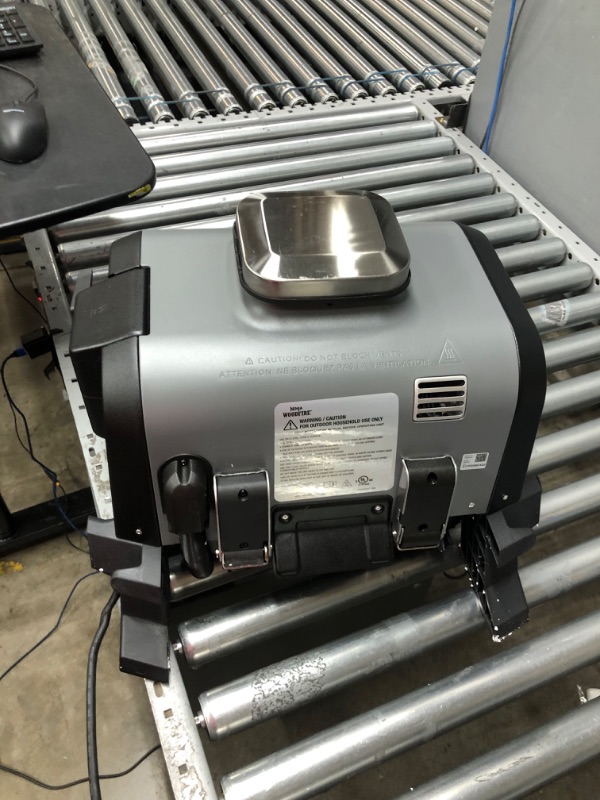 Photo 1 of Ninja OG701 Woodfire Outdoor Grill & Smoker, 7-in-1 Master Grill, BBQ Smoker, & Air Fryer plus Bake, Roast, Dehydrate, & Broil, uses Ninja Woodfire Pellets, Weather-Resistant, Portable, Electric, Grey