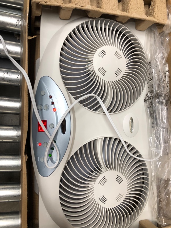 Photo 2 of **INCOMPLETE**Bionaire Window Fan with Twin 8.5-Inch Reversible Airflow Blades and Remote Control, White White 2 Blades Electronic control with LCD screen Window Fan