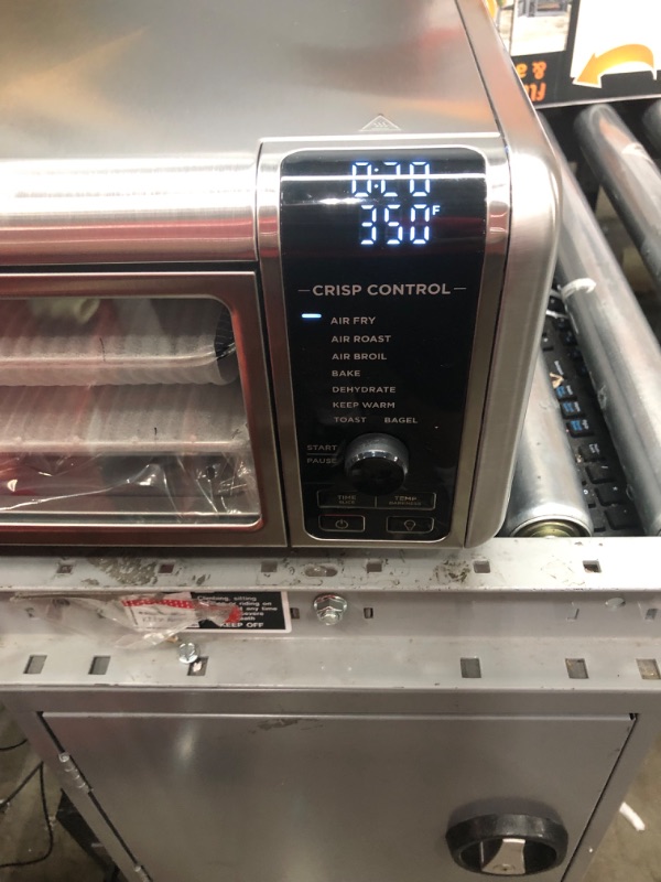 Photo 2 of Ninja SP101 Digital Air Fry Countertop Oven with 8-in-1 Functionality, Flip Up & Away Capability for Storage Space, with Air Fry Basket, Wire Rack & Crumb Tray, Silver
