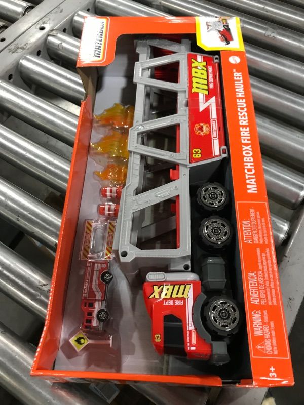 Photo 3 of ?Matchbox Fire Rescue Hauler Playset Themed Hauler with 1 Fire-Themed Vehicle, Holds 16 Cars, Easy-Release Ramp, 8 Accessories & Storage, for 3 & Up [Amazon Exclusive]