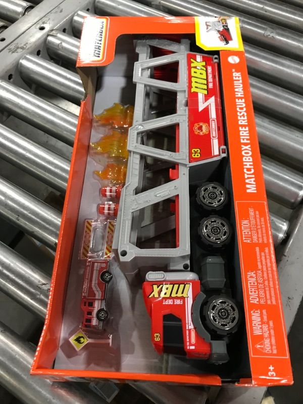 Photo 2 of ?Matchbox Fire Rescue Hauler Playset Themed Hauler with 1 Fire-Themed Vehicle, Holds 16 Cars, Easy-Release Ramp, 8 Accessories & Storage, for 3 & Up [Amazon Exclusive]