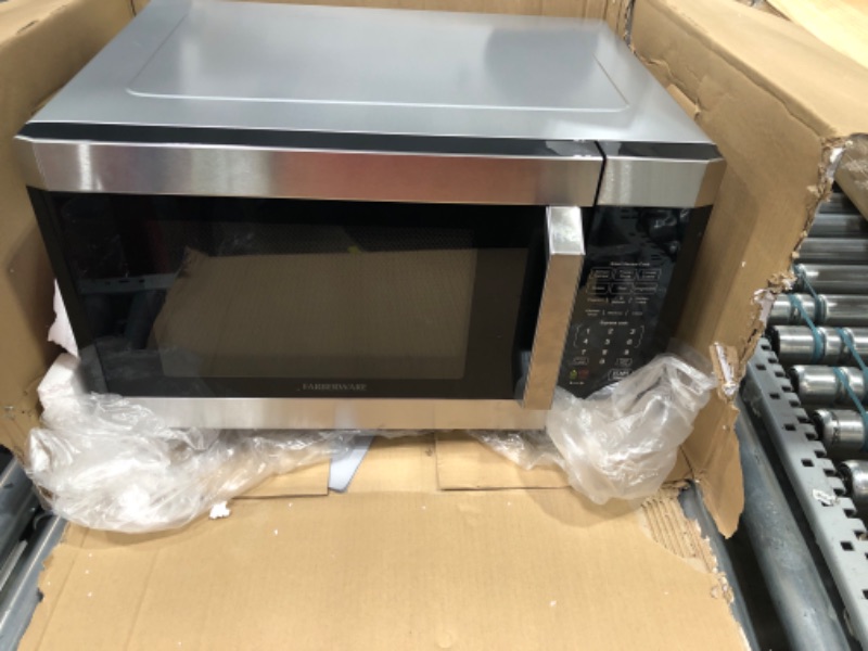 Photo 2 of ****PARTS ONLY NON FUNCTIONING**** Farberware Countertop Microwave 1100 Watts, 1.6 cu ft - Smart Sensor Microwave Oven With LED Lighting and Child Lock - Perfect for Apartments and Dorms - Easy Clean Stainless Steel with Platinum 1.6 Cu. Ft Stainless Sens